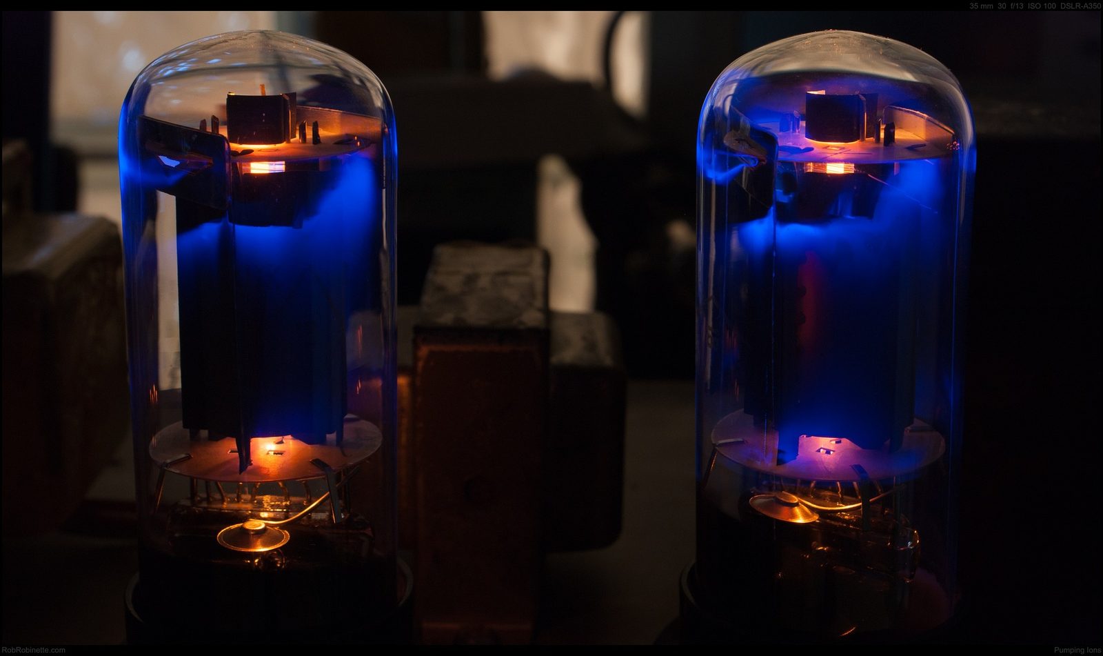Vacuum tubes glowing in a darkened amplifier chassis